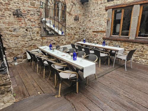 a row of tables and chairs on a patio at Hotel zur Brücke in Herzogenrath
