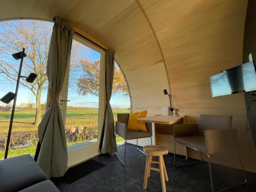 a room with a table and a large window at Eco-lodge locatie Dalfsen in Dalfsen