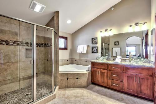 a bathroom with a shower and a tub and a sink at Conifer Chalet in South Lake Tahoe