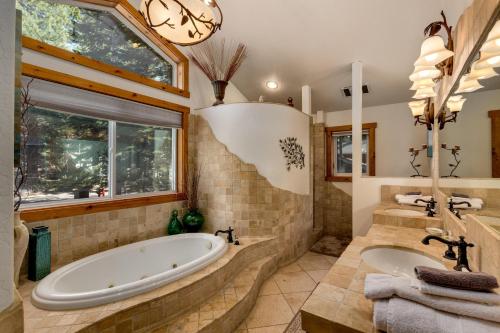 a large bathroom with a tub and a sink at Sundown Lodge in Stateline