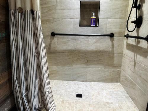 a shower with a shower curtain in a bathroom at Inn at Sunset Mill Ranch in Wimberley