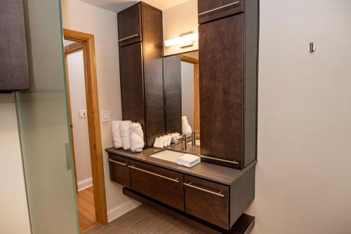 a bathroom with a sink and a mirror at Modern Lofts next to Georgia St. & Convention Ctr. in Indianapolis