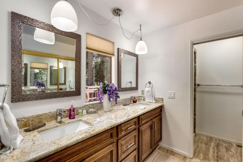 a bathroom with two sinks and two mirrors at Spacious Riverfront in South Lake Tahoe