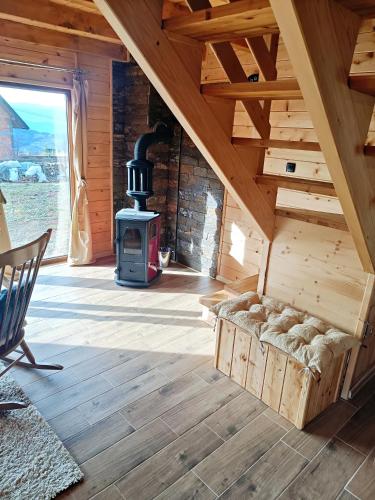 a room with a wood stove in a cabin at Vila Planinski san 1 in Zaovine