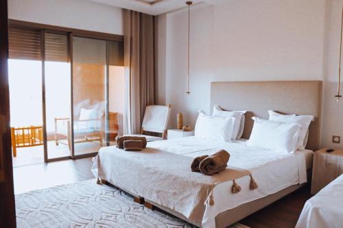 a hotel room with a bed with a bag on it at Villa Alma, luxueuse villa au cœur de Marrakech in Marrakesh