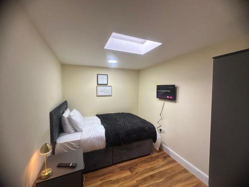 a bedroom with a bed and a skylight at Experience Downing Road Dagenham 2 bedroom Apartment in Dagenham