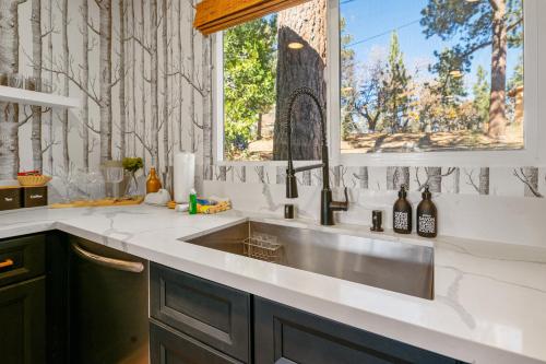 a kitchen with a sink and a window at Ski View Chalet - Prepare to be awestruck with the breathtaking and massive mountain views! in Big Bear Lake