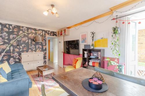 a living room with a couch and a table at Vibrant 1BD Flat - 8 Mins to Dalston Hackney! in London