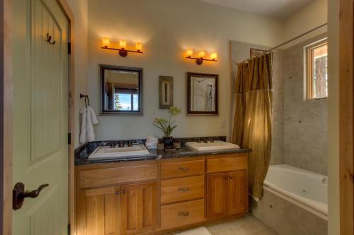 a bathroom with two sinks and a bath tub at Rock Haven in Stateline