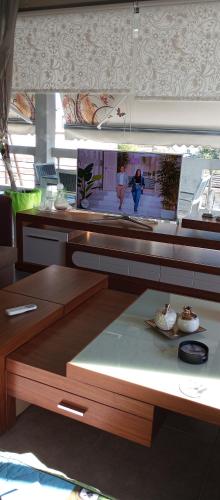 a kitchen with a counter with a table with a plate at Lia Luxury home 2ΥΔ 110 τ μ in Chrysoupolis