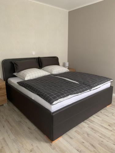 a bed in a room with a black mattress at Residence Anke 