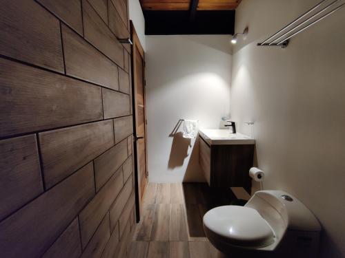 a bathroom with a toilet and a sink at Casa Ilhe Ha in Santa María Tonameca