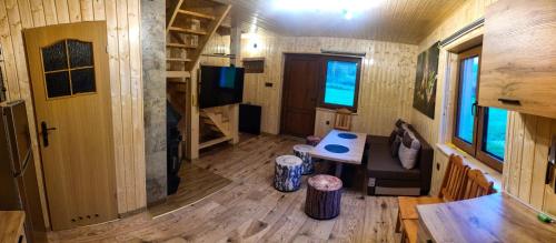 a view of a living room of a tiny house at Domki - Noclegi Pod Ostrym Działem in Ustrzyki Dolne