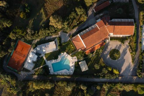 an aerial view of a house with a swimming pool at Nafsika Hotel - Adults Only in Dassia