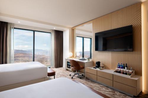 a hotel room with a bed and a desk and a television at Durango Casino & Resort in Las Vegas