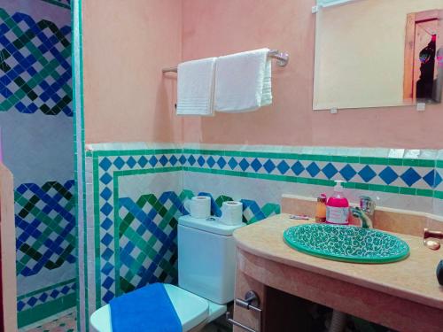 a bathroom with a toilet and a sink at Riad Dar Lalj Fes in Fez