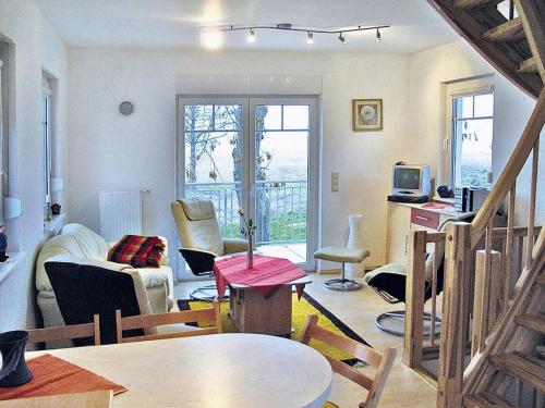 a living room with a couch and a table at Cottage on the Kummerower See, Kummerow in Kummerow