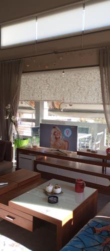 a living room with a couch and a table at Lia Luxury home 2ΥΔ 110 τ μ in Chrysoupolis
