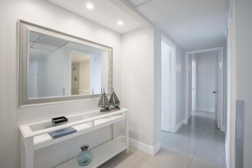 a white bathroom with a sink and a mirror at Ocean Reserve 14th floor - Wonderful Ocean View - STR00454 in Miami Beach