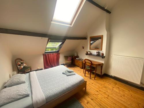 een slaapkamer met een bed, een bureau en een raam bij B&B Faja lobi in Gent