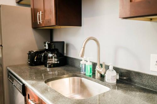 a kitchen counter with a sink and a mixer at Walkable and Spacious Apt - Parking -- GroupStay in Pittsburgh