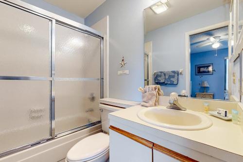 a bathroom with a sink and a shower and a toilet at Buddy's Place at the Beach in New Smyrna Beach