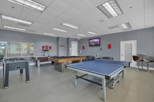 a gaming room with ping pong tables and a tv at Zeus' Sanctuary Ocean View In Brickell Miami in Miami