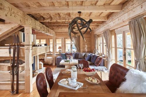 a living room with a couch and a table at GORSKA OSADA Lovely Chalets Zakopane in Poronin