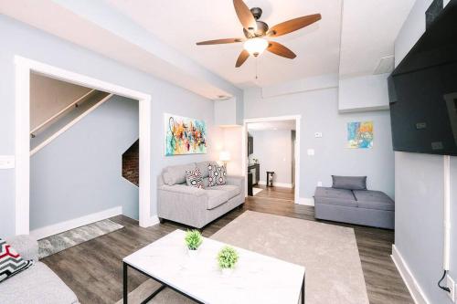 a living room with a couch and a ceiling fan at High-Speed Internet - Parking - Washer & Dryer in Pittsburgh