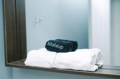 a towel sitting on top of towels in front of a mirror at High-Speed Internet - Parking - Washer & Dryer in Pittsburgh