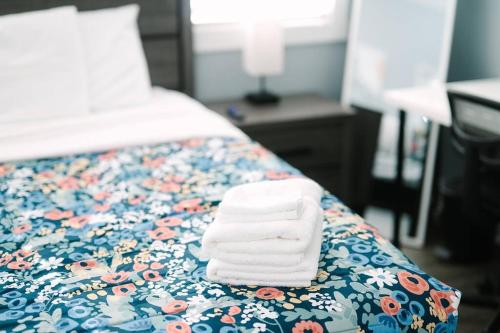 a pile of towels sitting on top of a bed at High-Speed Internet - Parking - Washer & Dryer in Pittsburgh