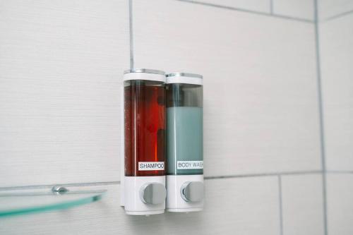 a couple of thermos bottles sitting on a bathroom counter at High-Speed Internet - Parking - Washer & Dryer in Pittsburgh