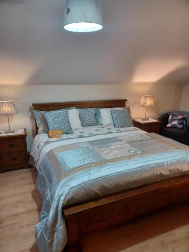 sypialnia z dużym łóżkiem z niebieskimi poduszkami w obiekcie Country Haven eircode H54 AK31 w Galway