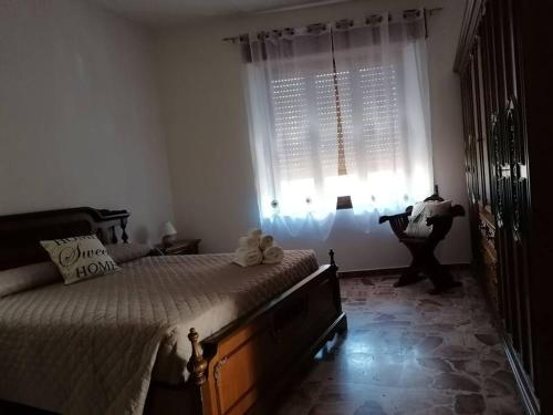 Ένα ή περισσότερα κρεβάτια σε δωμάτιο στο Mistral house - alloggio sud ovest della Sardegna