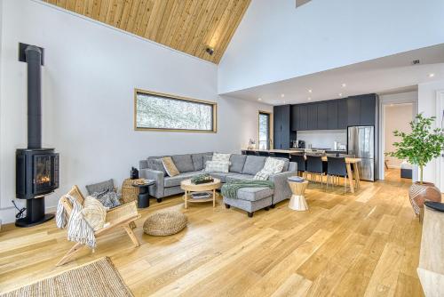 a living room with a couch and a fireplace at Snohaus 9 - Scandinavian Mountain Chalet in Mont-Tremblant