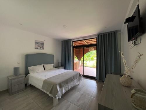 a bedroom with a bed and a television in it at Casa dos Arcos in Gueima