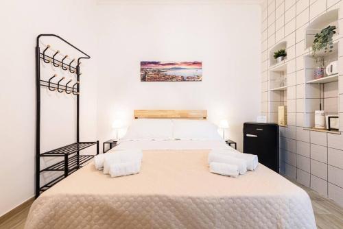 a bedroom with a large bed with two pillows at Vomero Dream Naples in Naples