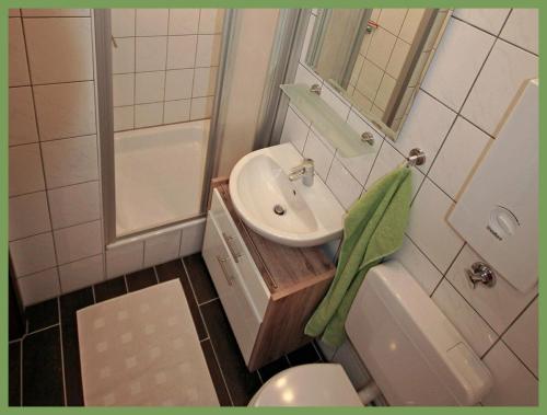 a small bathroom with a sink and a toilet at Apartment SONNE - Gute-Nacht-Braunschweig in Braunschweig
