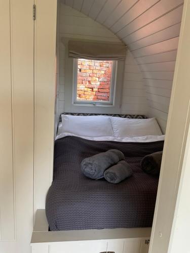 a bed in a small room with a window at Secluded Cosy Luxury Pod in Shrewsbury