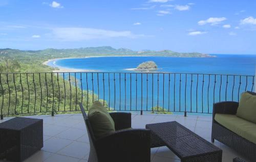 a balcony with a view of a beach and the ocean at Playa Flamingo - 2 BR condo with great ocean views - FLAMINGO TOWERS 25 in Playa Flamingo