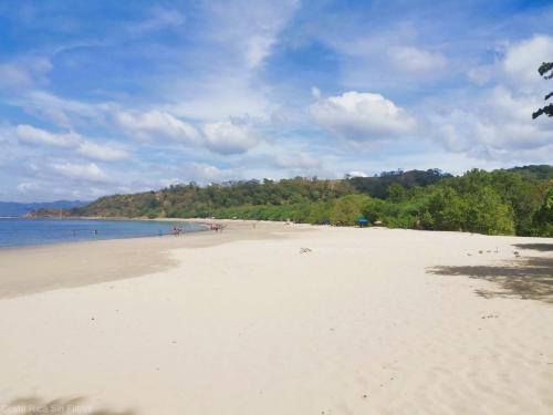 a beach with a lot of people in the water at Playa Flamingo - 2 BR condo with great ocean views - FLAMINGO TOWERS 25 in Playa Flamingo