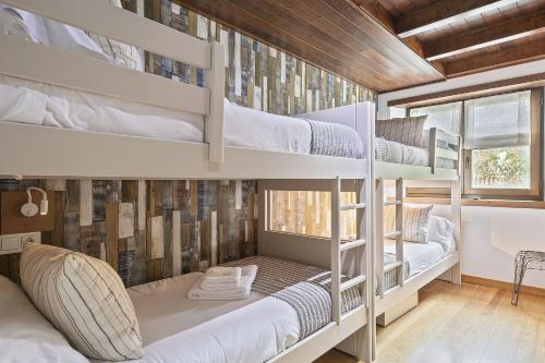 a bunk bed room with three bunk beds in it at Luderna - Apartamento Val de Ruda B15 Baretja in Baqueira-Beret