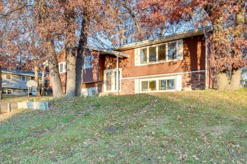 a house with a tree in front of it at 7 Mi to Munsinger Gardens Sartell Home with Deck in Sartell