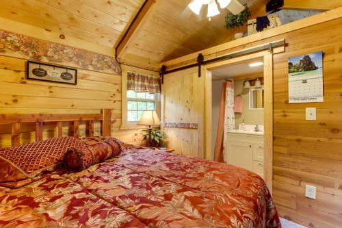 a bedroom with a bed in a log cabin at Idyllic Florence Cabin with Grill and Creek Views in Florence