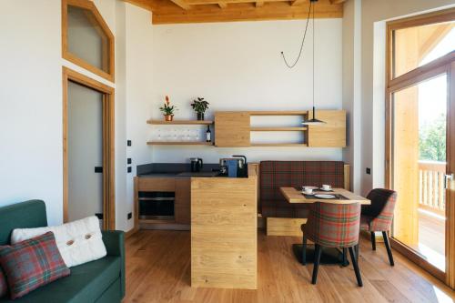 a living room with a kitchen and a table at Chalet M in Val di Zoldo
