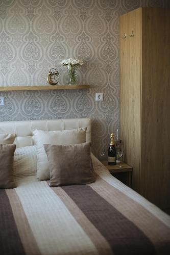 a bedroom with a bed with a vase on the wall at Hotel Banja Luka in Banja Luka