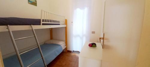 a small room with a bunk bed and a ladder at Margherita sul mare - 250 m from the beach in San Giorgio