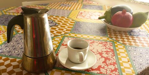 a coffee pot and a cup of coffee on a table at Margherita sul mare - 250 m from the beach in San Giorgio