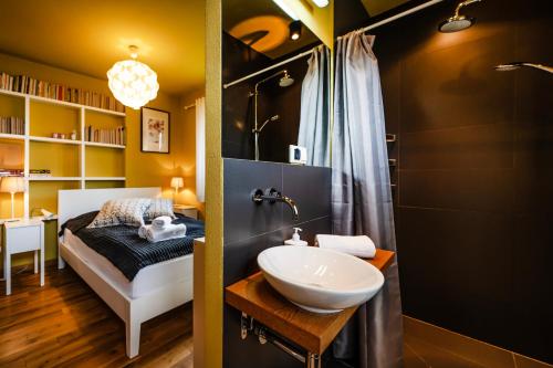 a bathroom with a sink and a bed in a room at Sokołówka in Muszyna