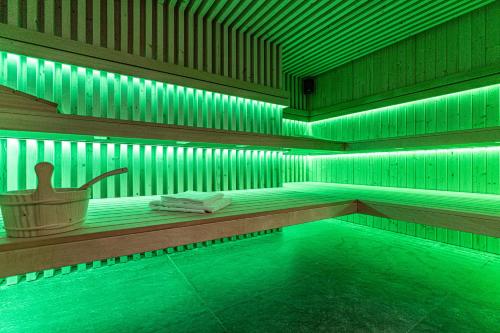 a swimming pool with green lights in a building at Aparthotel Zakopiański & SPA in Zakopane